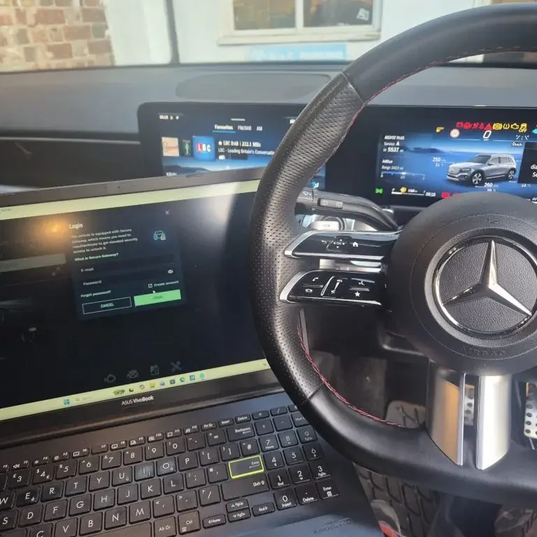 A laptop displaying diagnostic data from a Mercedes car.